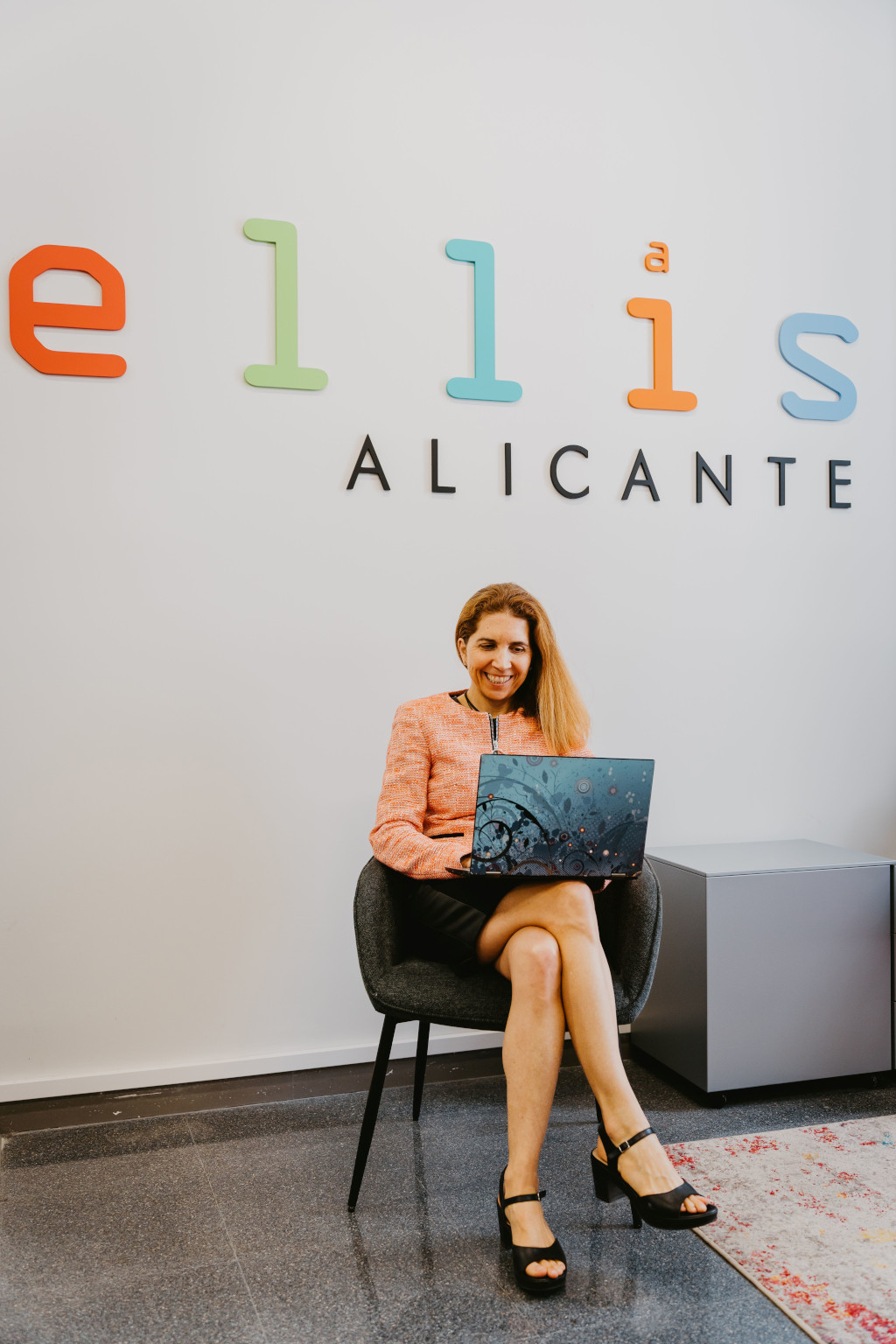 Nuria Oliver in a chair under ELLIS sign